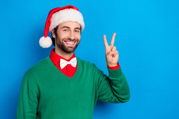 Wall Mural - Portrait of positive person beaming smile arm fingers demonstrate v-sign isolated on blue color background