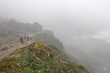 People walking in foggy mountains