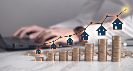 Wall Mural - Real estate agent showing house and stack of coins. Real Estate Graph. House market growth