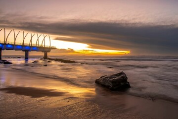 Canvas Print - Mesmerizing long exposure shot of a sunset over the beach with soft sea waves