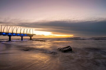 Poster - Mesmerizing long exposure shot of a sunset over the beach with soft sea waves