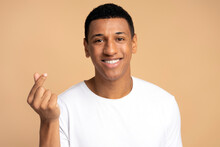 Portrait Of Attractive Positive Guy Smiling And Showing Give Me Money Gesture