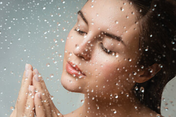Wall Mural - portrait of sensual woman captured through wet glass