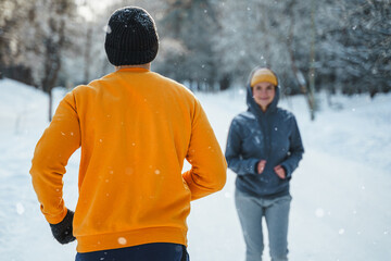 Wall Mural - Sportive couple during winter jogging in city park