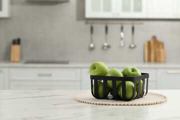 Wall Mural - Fresh green apples on white table in kitchen, space for text