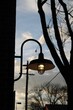 Vertical shot of a street lamp against a blue sky