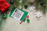 Fototapeta Desenie - Composition with greeting card, fir branches and Christmas decorations on light background