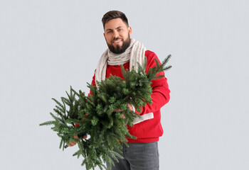 Sticker - Handsome man with Christmas tree on grey background