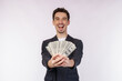 © Johnstocker - Portrait of a cheerful man holding dollar bills over white background