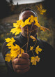 © bogdan vacarciuc - A man holds a branch with yellow leaves. The arrival of autumn.