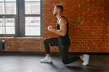 Wall Mural - Muscular, sportive man practicing squats