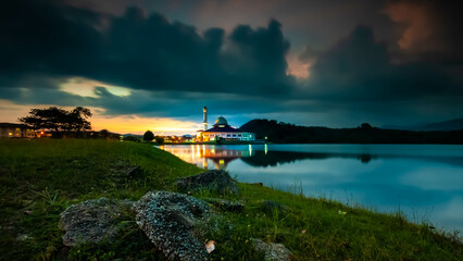 Wall Mural - Beautiful view of Darul Quran mosque with reflections during sunset at Kuala Kubu, Selangor, Malaysia. The image may has blurred effect and soft focus due to long exposure.