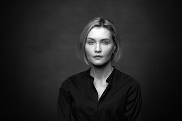 Wall Mural - Dramatic black and white portrait of a beautiful woman on a dark background