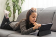 © Angelov - Happy teenager girl on line with a laptop in the living room at home