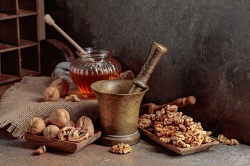 Walnuts and honey on a kitchen table.