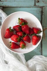 Sticker - Closeup of fresh red strawberries in a kitchen