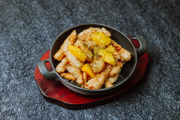 Wall Mural - Chinese food sweet and sour pork dish in black bowl