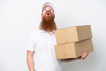 Wall Mural - Delivery reddish man isolated on white background looking up and with surprised expression