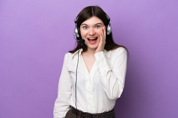 Wall Mural - Telemarketer Russian woman working with a headset isolated on purple background with surprise and shocked facial expression