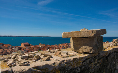 A stone wall overlooking the old medieval centre of Piran on the coast of Slovenia
