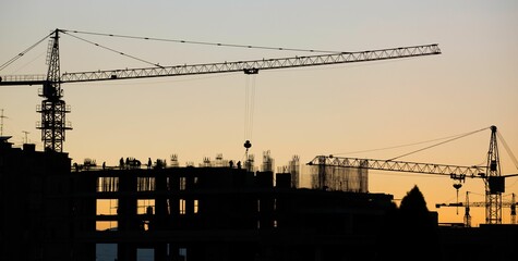 Canvas Print - View of the crane and construction on a sunset