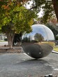 Giant mirror reflecting ball along the Little Sugar Creek Greenway in uptown Charlotte, NC