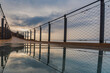 © M. Perfectti - Jolucar suspension walkway, in Torrenueva Costa, Granada, view of the glass floor with the cloudy sky at dawn reflected on the glass.