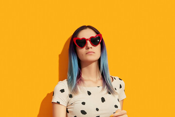 Poster - Hipster woman with blue hair wearing sunglasses. Serious caucasian girl looking up