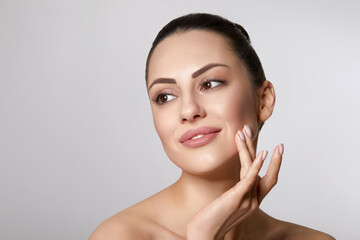 skin care. woman with beauty face touching healthy facial skin portrait. beautiful smiling girl mode