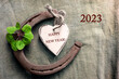 2023 Happy NEW YEAR decoration with four leaf clover and horseshoe with text