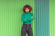 © carballo - afro american latin girl in the street on green background with green sweater