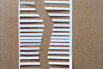 Sticker - cut paper shape with stripes or fringes on corrugated paper background