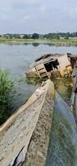 Sticker - Vertical of sunken house ruins in a lake with a shabby roof in the foreground