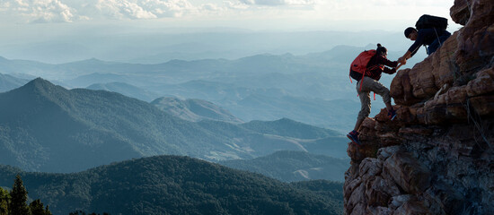 asia couple hiking help each other on mountains