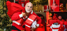 Criminal Santa Posing With A Steal Bag Of Christmas Gifts. Bad Santa Concept. Funny Bad Santa Claus With Gift, Bag With Stolen Presents.
