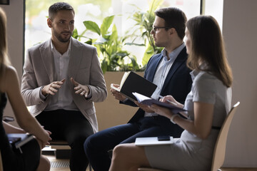 Sticker - Group of businesspeople negotiating gathered in office, colleagues listen to team leader or boss during briefing, jotting received information, corporate goals and work results, take part in teamwork