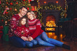 © ZaStock - Loving Christmas family posing near Christmas tree over decorated living room background