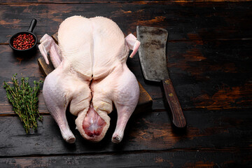 Wall Mural - Gressingham duck ready to cook with herbs, on old dark  wooden table background, with copy space for text