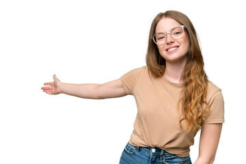 Wall Mural - Young pretty woman over isolated background extending hands to the side for inviting to come