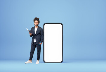 Poster - Middle eastern businessman with notebook and pen, big phone mock