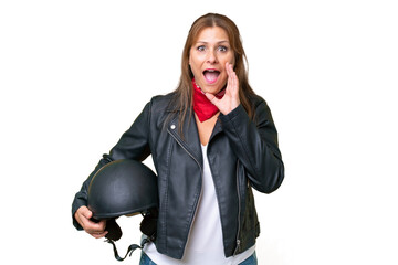 Middle-aged caucasian woman with a motorcycle helmet over isolated background with surprise and shocked facial expression