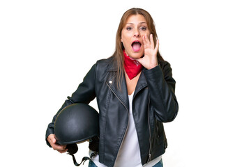 Canvas Print - Middle-aged caucasian woman with a motorcycle helmet over isolated background shouting with mouth wide open