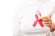 © sorapop - Female holding HIV AIDS awareness red ribbon on hands in studio shot isolated on over white background, Healthcare and medicine, World aids day concept