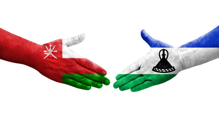 Handshake between Lesotho and Oman flags painted on hands, isolated transparent image.