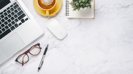 Wall Mural - Flat lay, White office desk with laptop computer, eyeglass, pen, mouse, notebook and coffee, Top view with copy space.