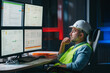 © leonidkos - Bearded operator of factory control industry process using monitors. Engineer follow on production line