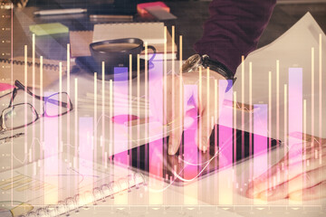Poster - Double exposure of man's hands holding and using a digital device and forex graph drawing. Financial market concept.