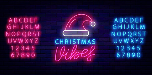 Wall Mural - Christmas Vibes neon signboard. Holiday mood. Shiny banner. Luminous blue and pink alphabet. Vector stock illustration