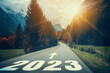 Leinwandbild Motiv 2023 New Year road trip travel and future vision concept . Nature landscape with highway road leading forward to happy new year celebration in the beginning of 2023 for fresh and successful start .