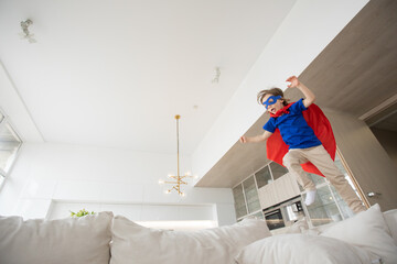 Wall Mural - Girl dressed like superhero jumping